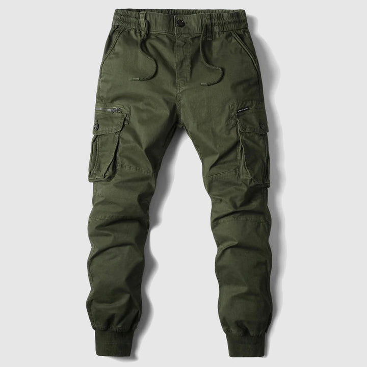 Close-up of men's slim fit cargo jogger pants, highlighting multi-pockets & adjustable waist for a modern utility look.