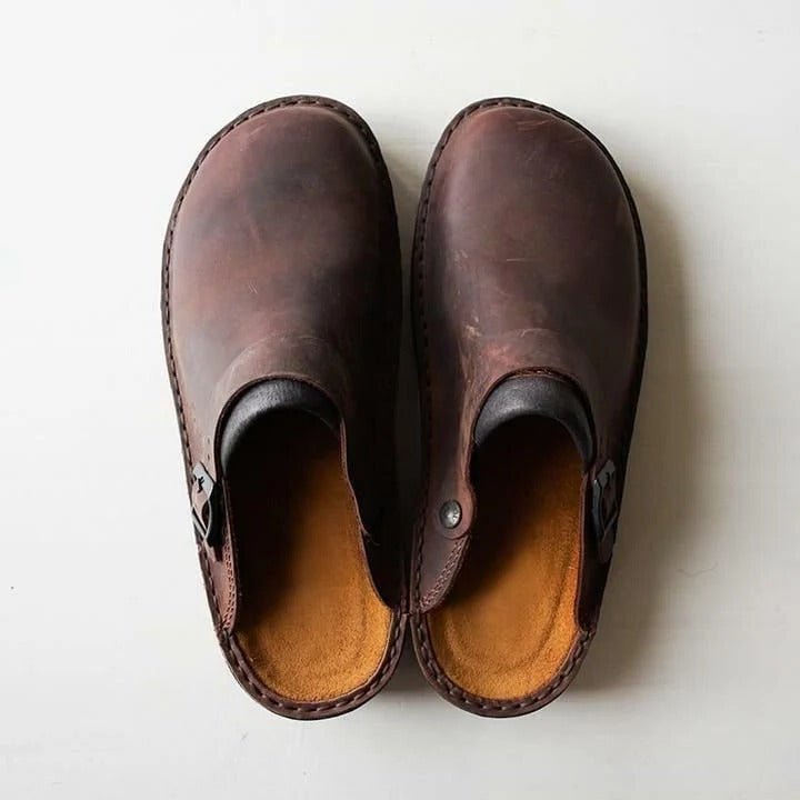 Men's slip-on mules with secure heel strap for casual everyday comfort and style.