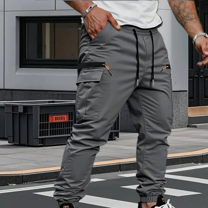 Comfortable men's stretch cargo joggers, versatile for casual wear or active lifestyles. Tapered fit, multi-pocket details.