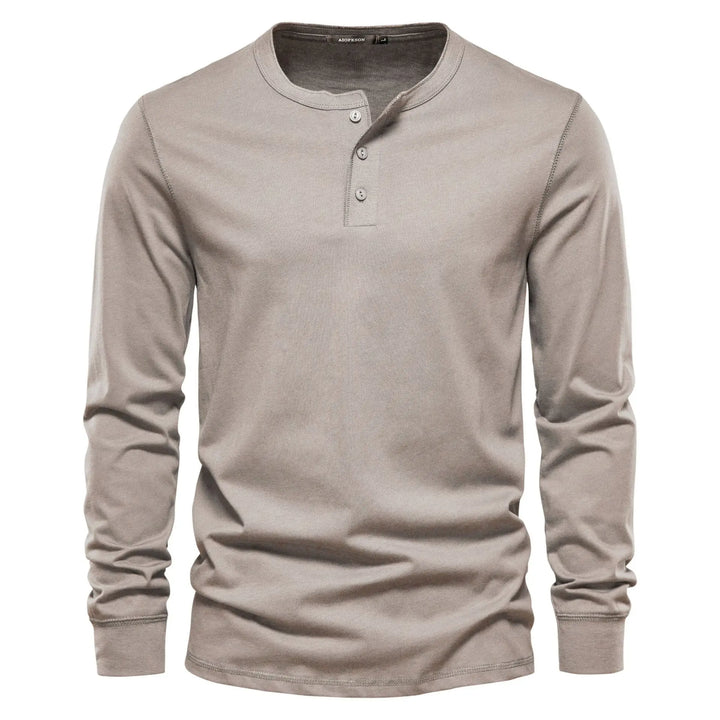 Textured fabric detail of a men's stylish long sleeve henley shirt, highlighting its comfortable feel