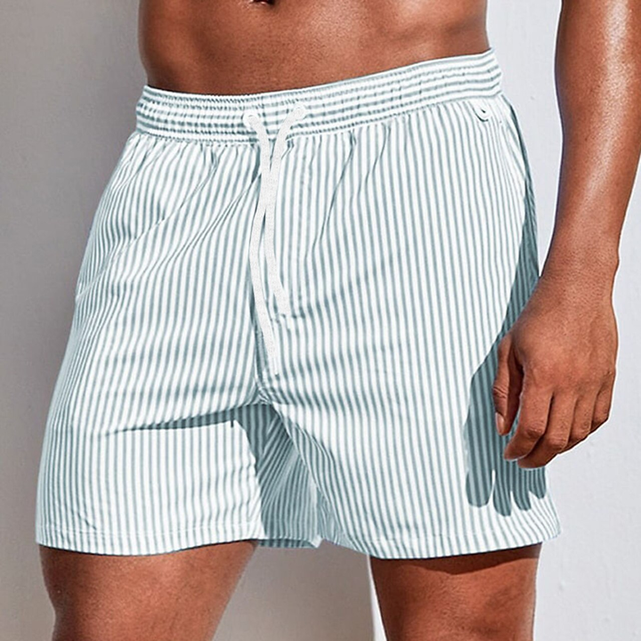 Comfortable men's quick-dry striped swim trunks with drawstring, perfect for poolside vacation.