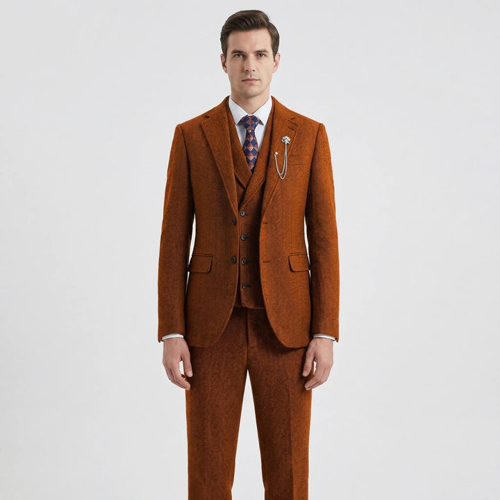 Model in a classic men's tailored fit 3-piece herringbone suit. Ideal gentlemen's fashion for formal occasions.