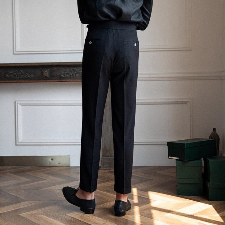 Elegant black men's tailored high-waist pleated pants. Comfortable straight leg dress trousers for office fashion.