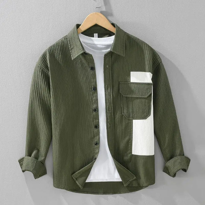 Men's textured button-up shirt in emerald green with black contrast patch detail, casual style