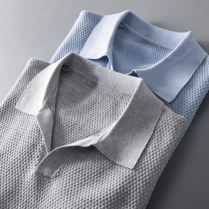 Close-up of a men's short sleeve polo, showcasing its unique textured geometric pattern.