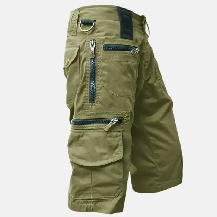 Practical men's utility shorts in knee-length, featuring multiple pockets for casual outings & adventure.