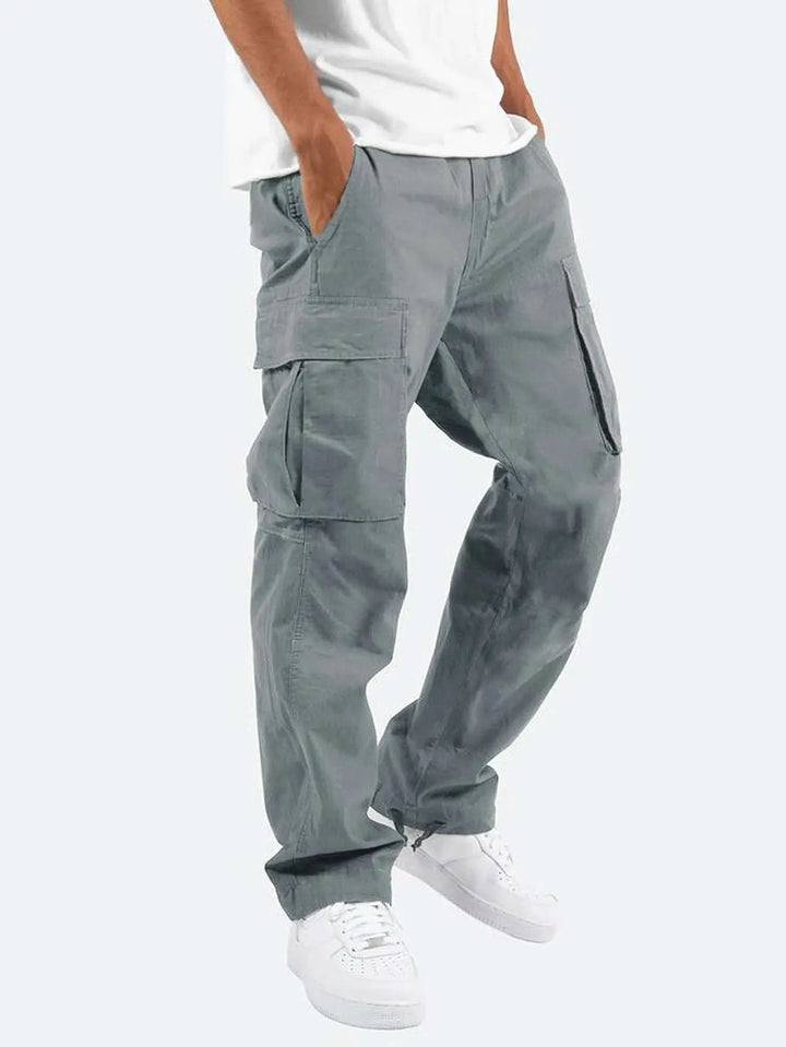 Man wearing stylish men's drawstring cargo pants, demonstrating comfortable relaxed fit for versatile everyday fashion.
