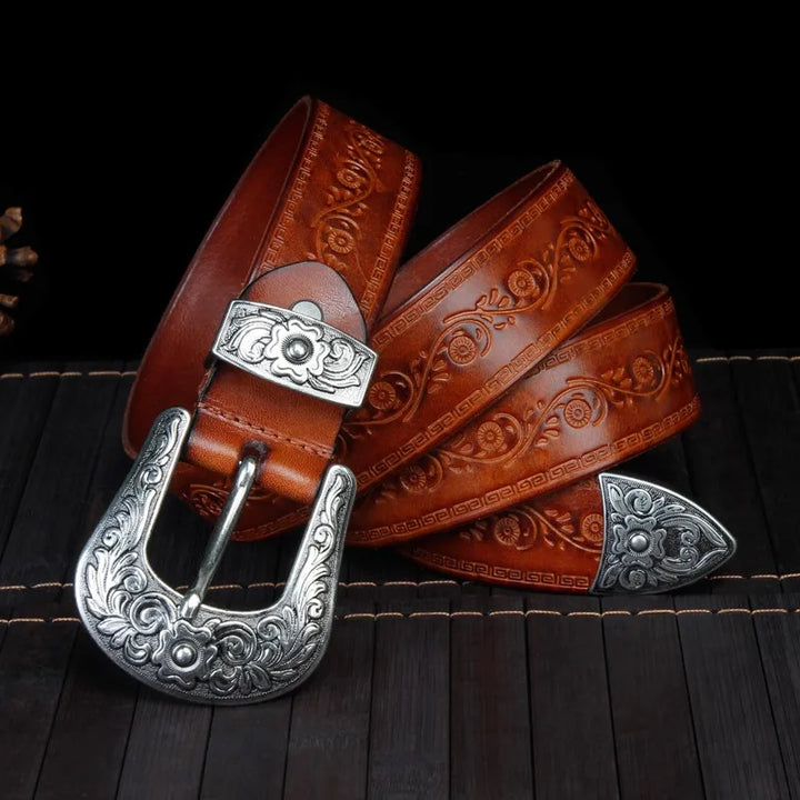Men's Western leather belt with intricate engraved metal buckle, perfect for cowboy style.
