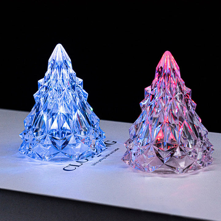 Close-up of a glowing mini LED crystal Christmas tree, a charming nightlight