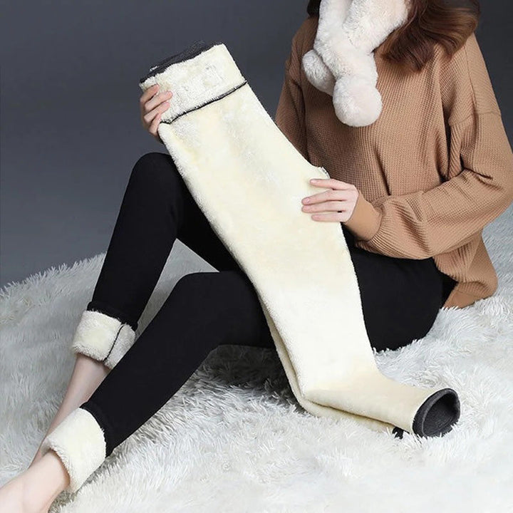 Model wearing black women's thermal fleece-lined winter leggings, high waist, plush lining for cold weather