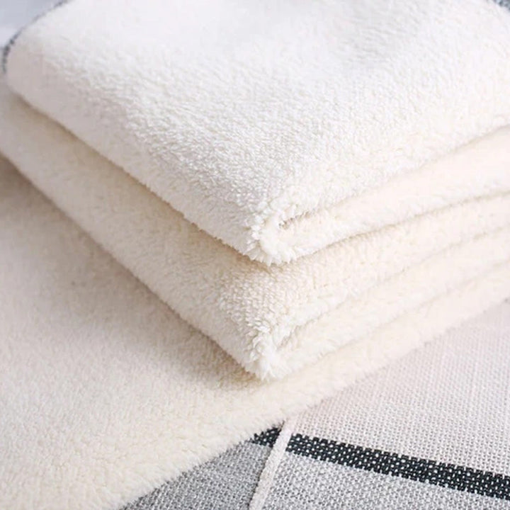 Folded black thermal fleece-lined leggings, showcasing their compact and soft texture