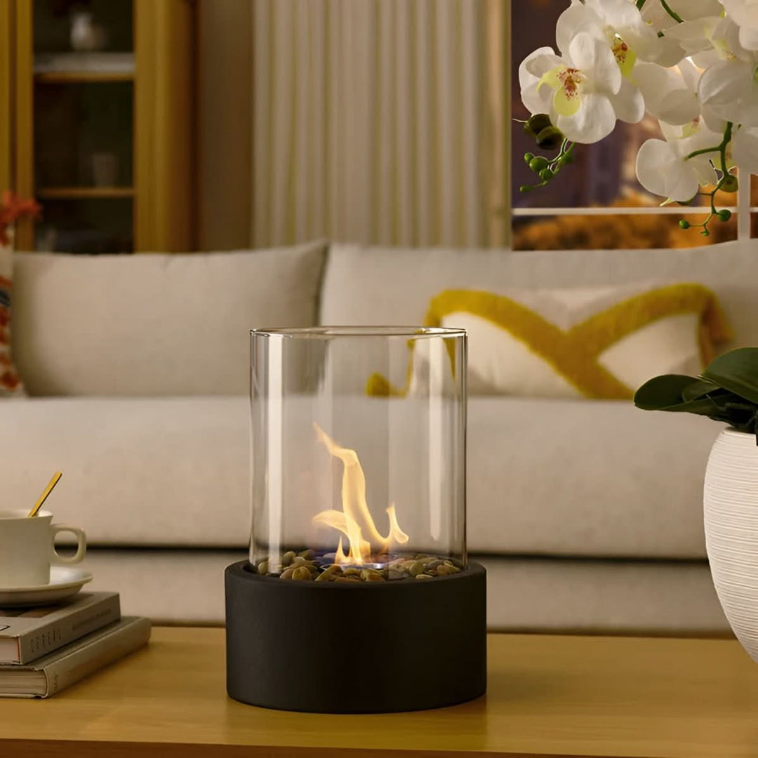 Sleek black tabletop bioethanol fireplace, a portable, smoke-free accent for modern indoor/outdoor decor.