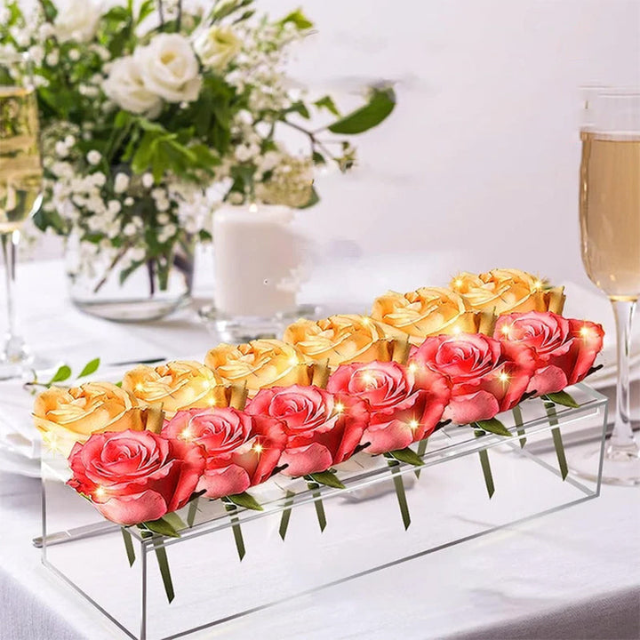 Stylish clear acrylic vase on a wooden table, enhancing a room's aesthetic with a fresh floral arrangement.