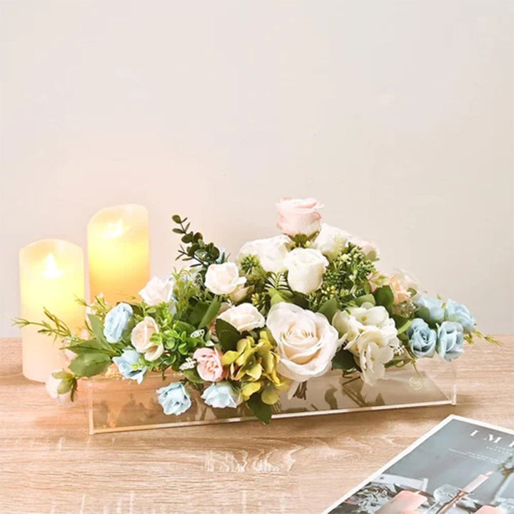 Modern transparent acrylic vase catching light, a versatile decor piece for offices and homes.