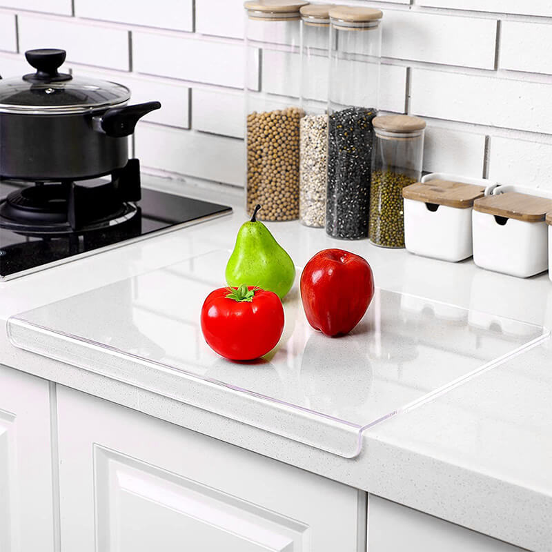 Sleek modern clear acrylic cutting board with non-slip feet, a chef essential for contemporary kitchens.