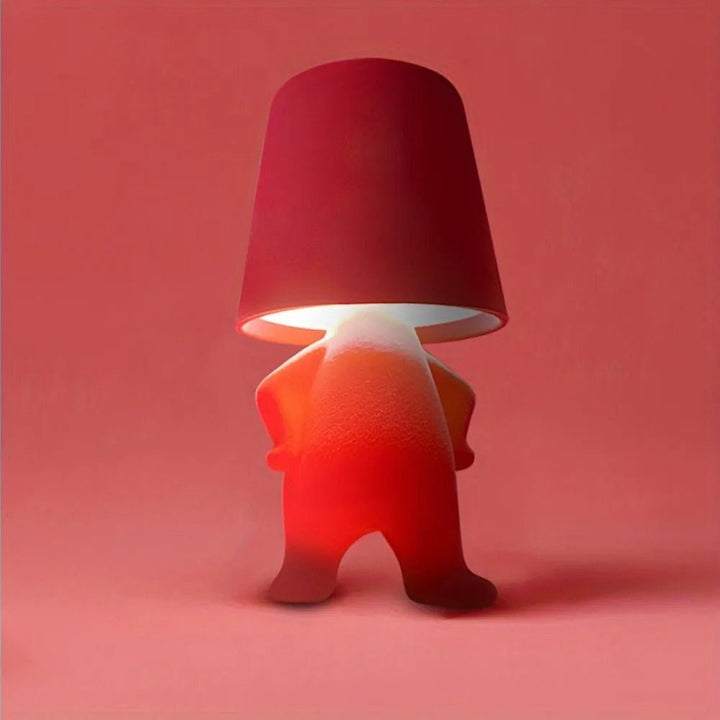 Creative humanoid LED desk lamp, a modern and rechargeable lighting solution for artistic rooms.