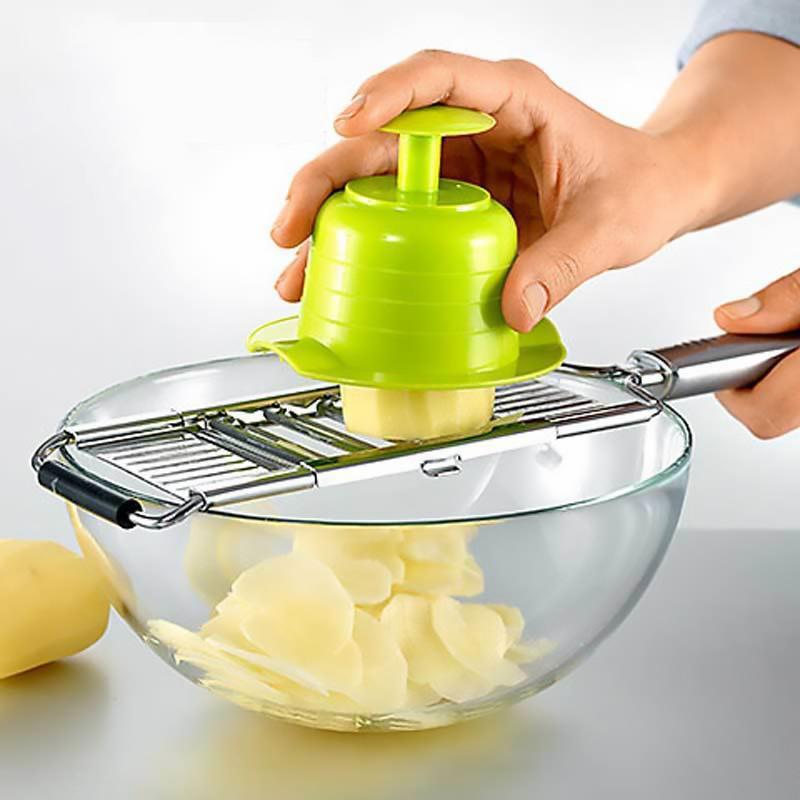 Hand operating a versatile vegetable slicer, dicing carrots and other produce efficiently