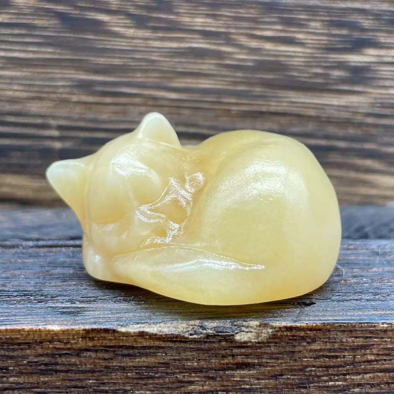 Stone cat sculpture, sleeping animal design, natural material, spiritual decor, garden ornament