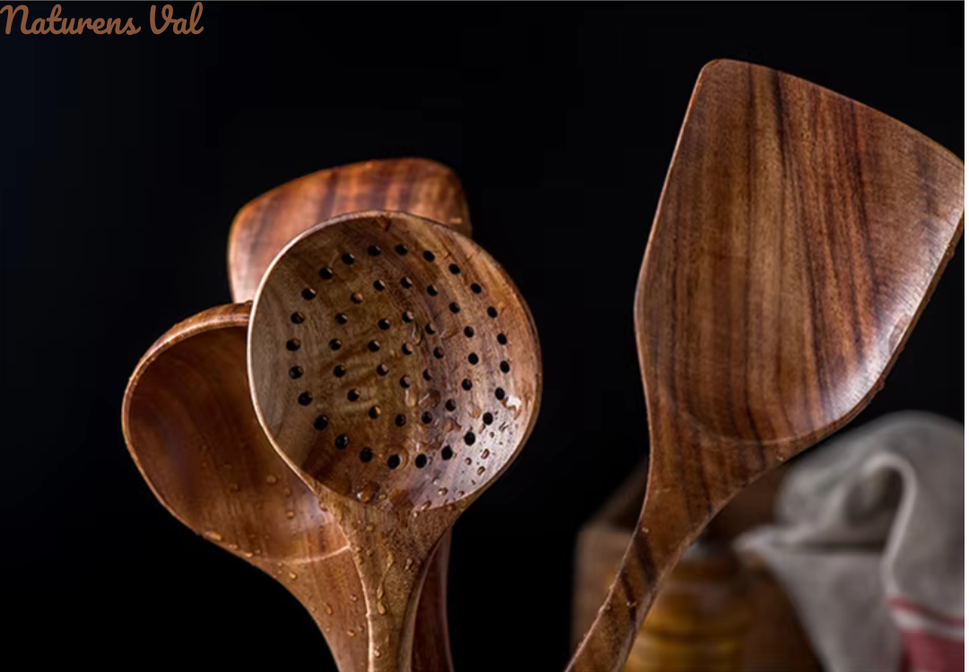 Variety of natural teak wood cooking tools: spoons, spatulas. Sustainable kitchen utensils for daily use.