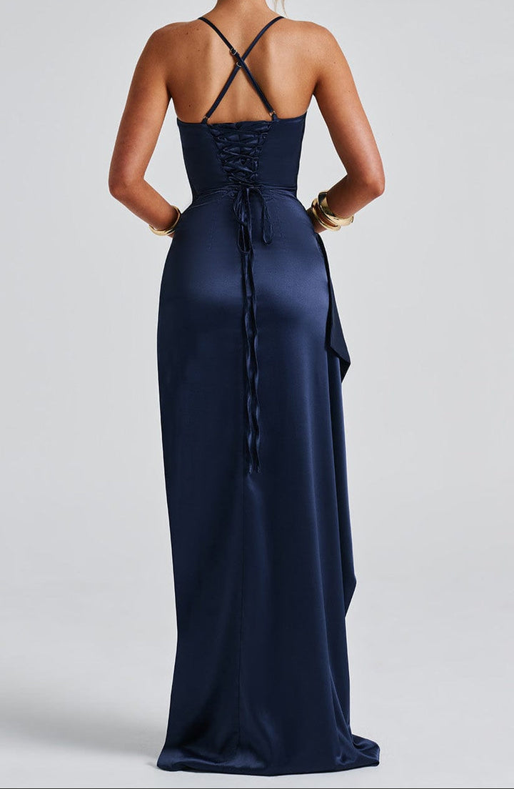 Full-length shot of a women's navy blue strappy dress with a sophisticated high slit detail
