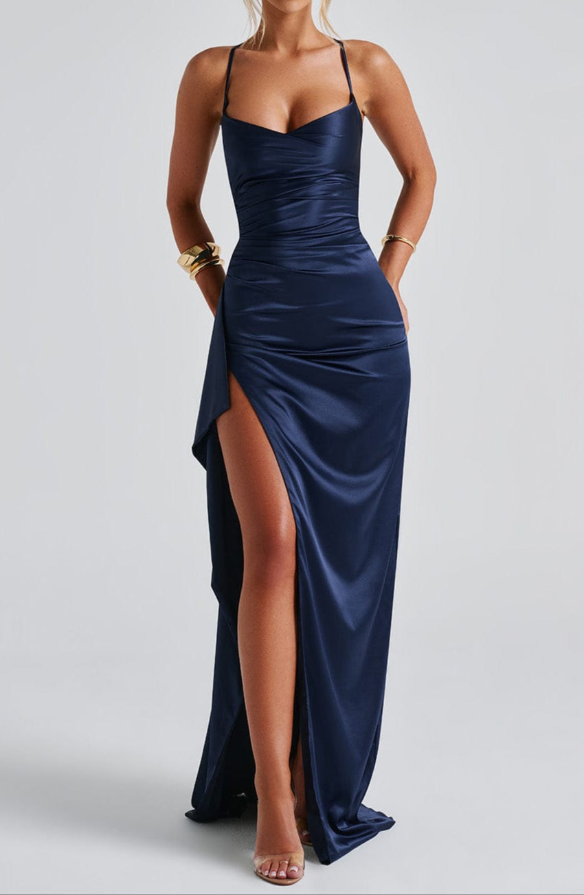 Close-up of the fabric and strappy detail on a women's navy blue high slit maxi dress