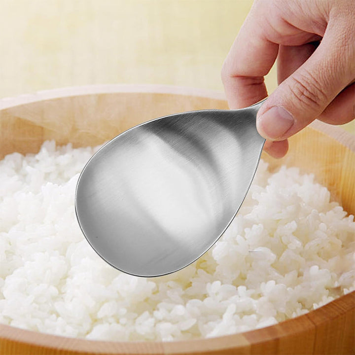 Shiny non-stick stainless steel rice spoon, designed for effortless cooking and serving