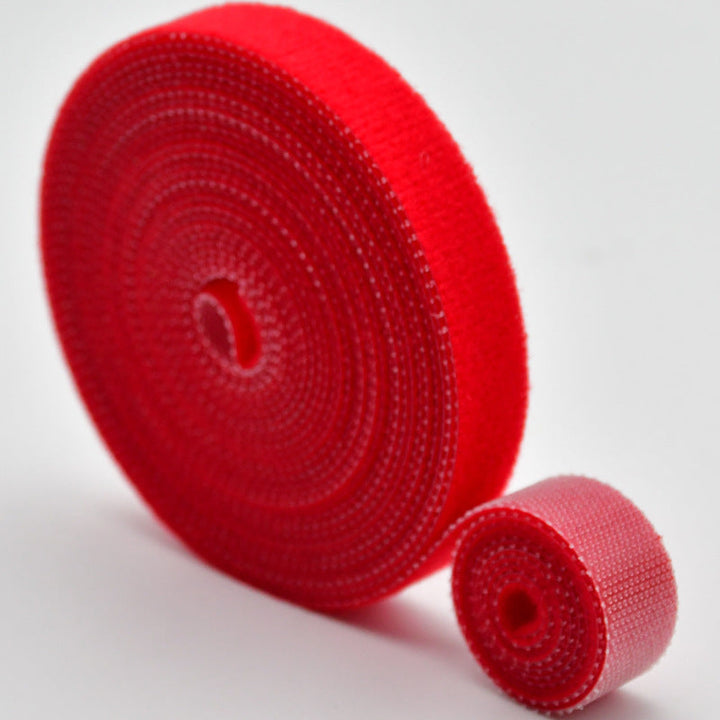 Stack of black reusable nylon cable tie rolls, essential tool for wire organization