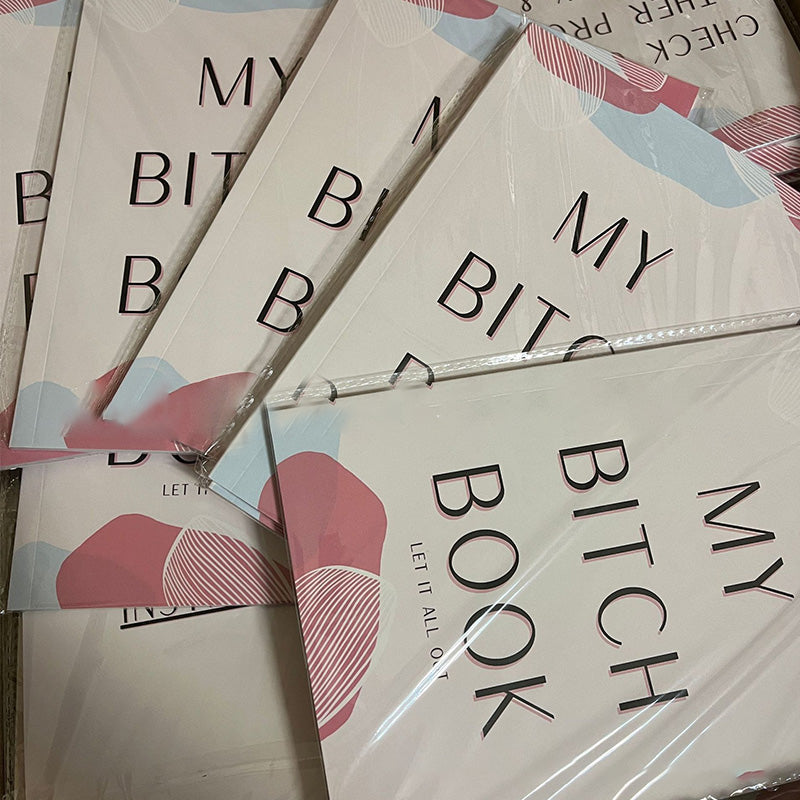 Adult stress relief journal and pen on a wooden desk, promoting self-care