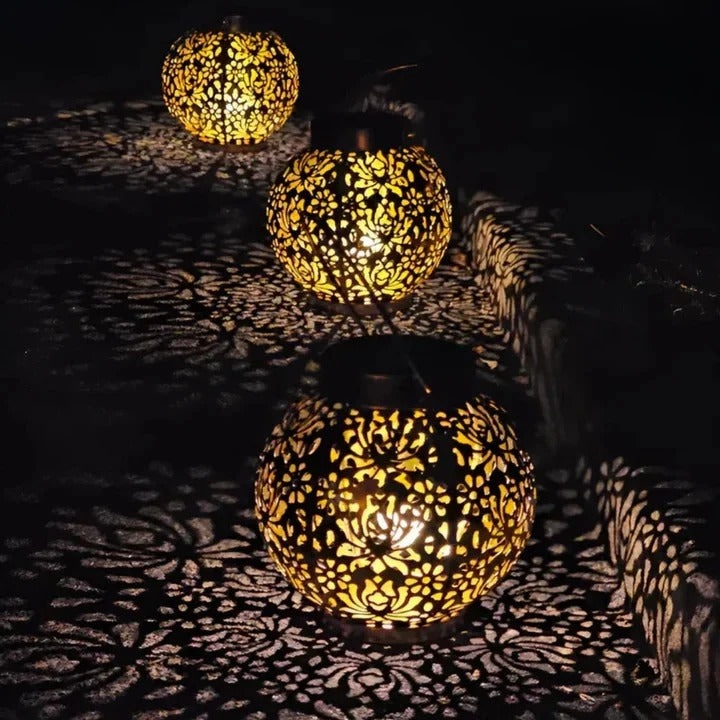 Bright outdoor LED solar pendant light providing ambient lighting for a garden, controllable via included remote.