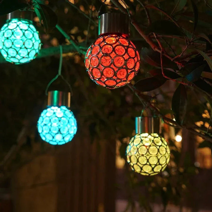 Close-up of a decorative solar hanging lantern with an intricate design, perfect for patio decor.