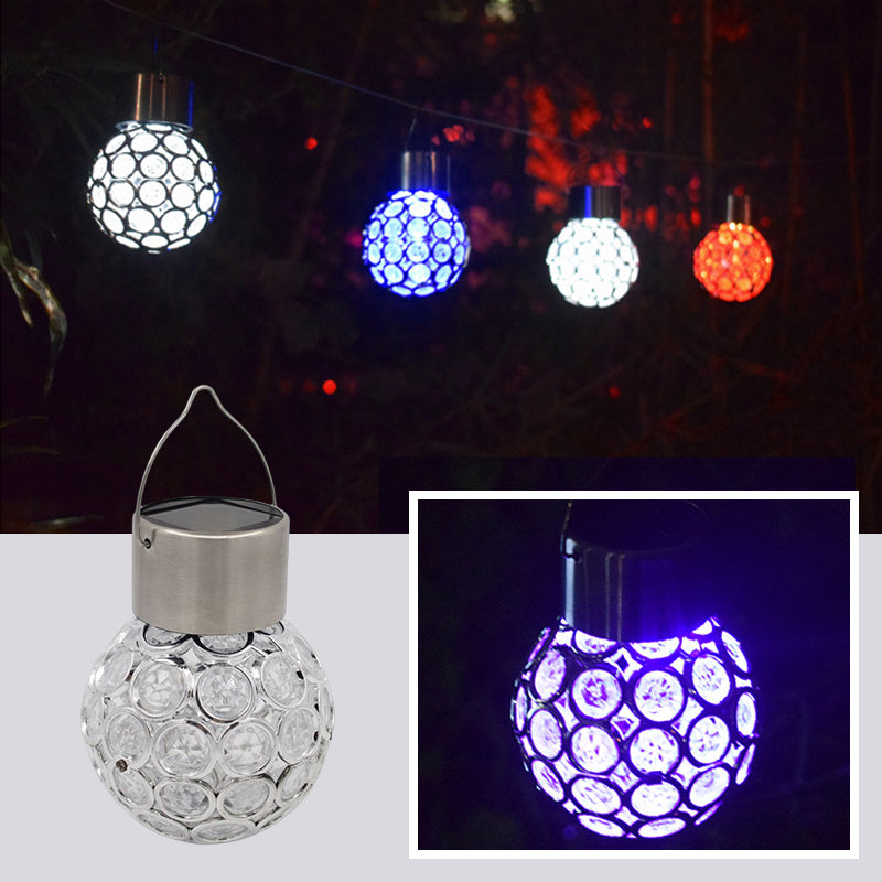 A set of two outdoor solar hanging lanterns adding ambiance to a backyard, solar powered garden lights.