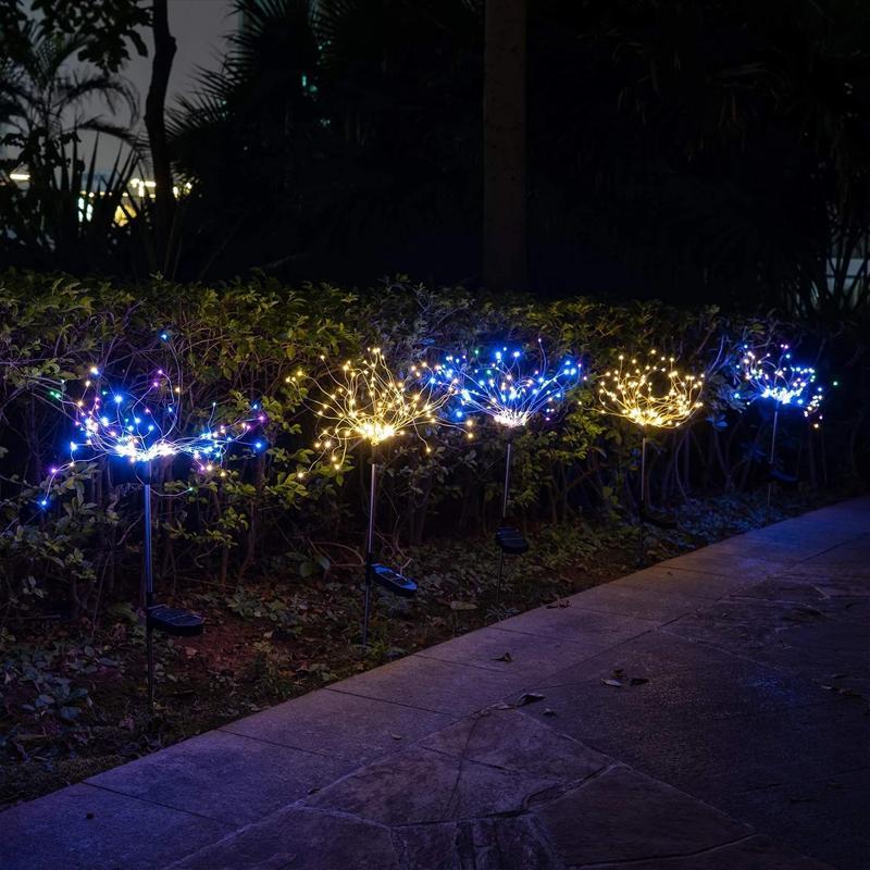 Night view of multiple solar firework garden lights, bright LED glow, festive outdoor decoration