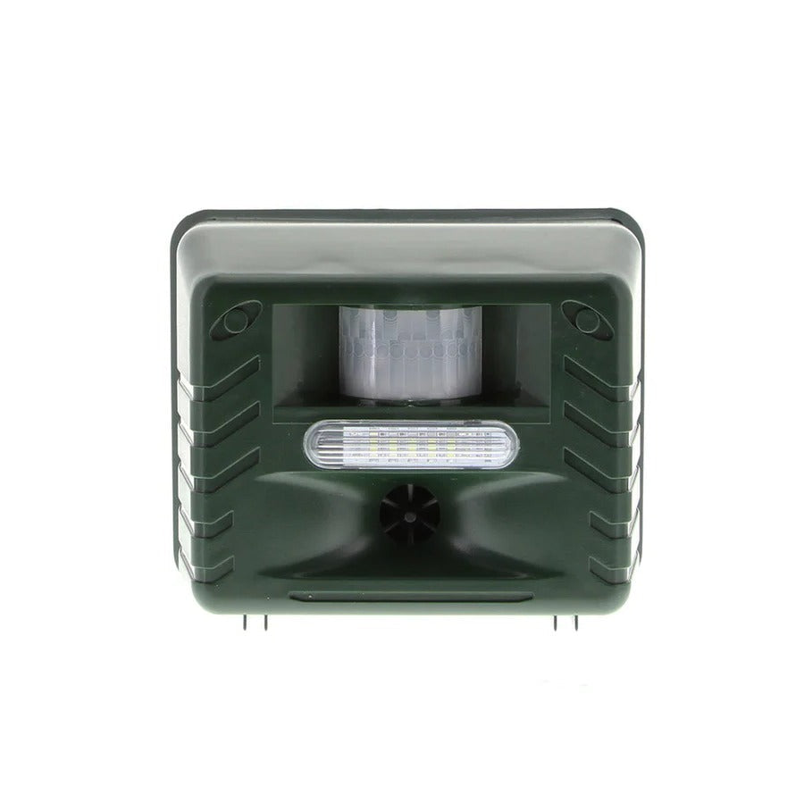 Solar outdoor bird repeller device mounted on a fence, deterring pigeons and woodpeckers from property.