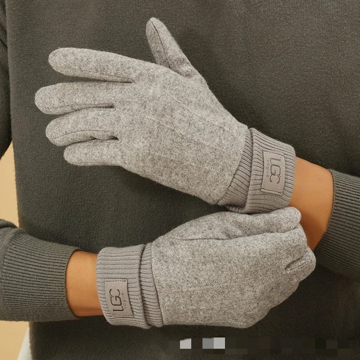Stack of folded cashmere touchscreen gloves in various colors: black, grey, beige, navy.