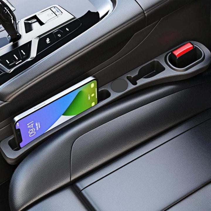 Car seat gap filler in a car, preventing items from falling between the seat and console.