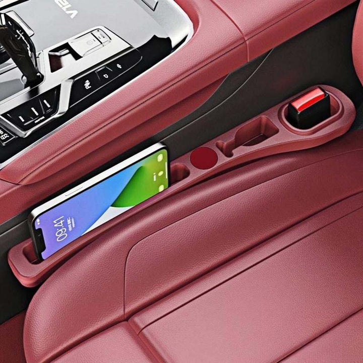 Decluttered car interior using car seat gap fillers, highlighting neat phone and wallet storage.