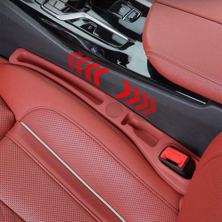 Driver's side car seat gap filler organizer, holding a smartphone, coins, and a pen.
