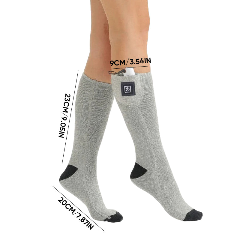 Model wearing heated socks indoors, demonstrating comfort and warmth off the slopes.