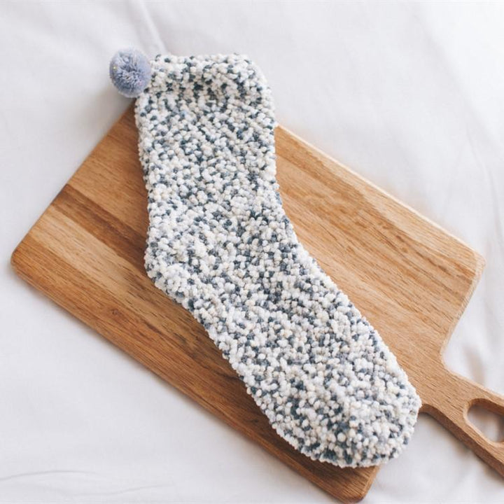 Women's apparel: fluffy cupcake slipper socks, a comfy and stylish winter accessory for home.