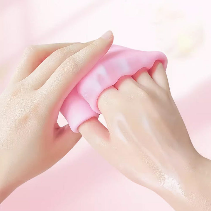 Pair of pink moisturizing gel gloves for dry, cracked hands, spa treatment at home.