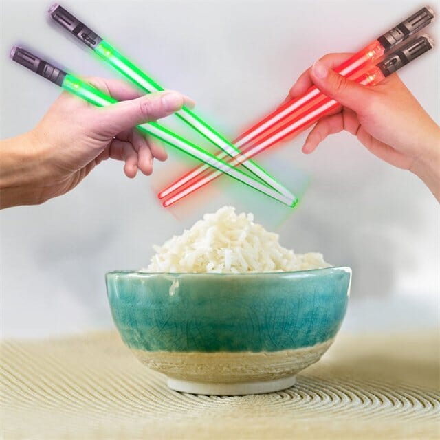 Unisex novelty Lightsaber LED chopsticks, glowing brightly in the dark, perfect for parties.