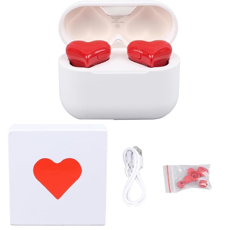 Close-up of pink heart wireless earbuds in charging case, sleek Bluetooth audio tech