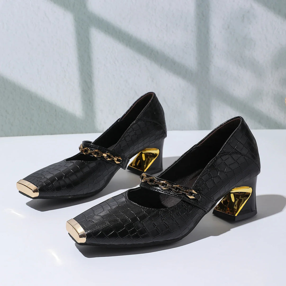 Faux leather black block heel pumps for women, enhanced with a classy chain detail and squared toe.