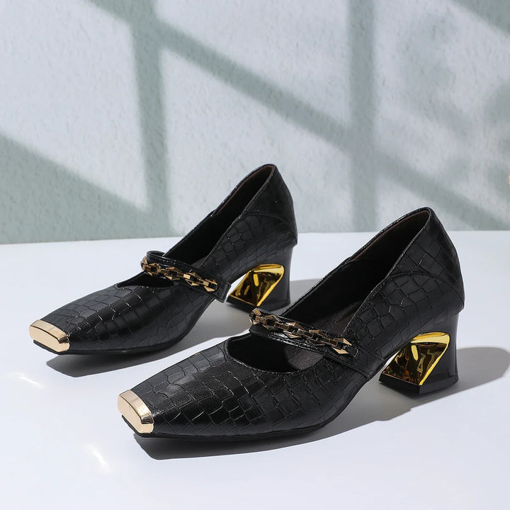Faux leather black block heel pumps for women, enhanced with a classy chain detail and squared toe.
