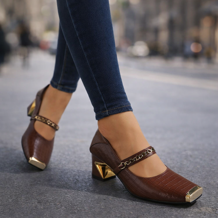 Red women's block heel pumps with stylish chain accent, squared toe, ideal for evening heels.