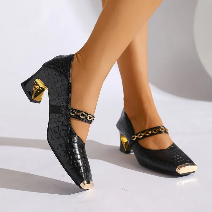 Side view of black women's block heel pump with chain detail, squared toe, and sturdy heel.