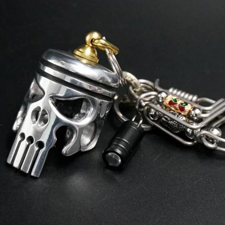 Unisex Piston Art Skull Keychain, rugged metal design, ideal motorcycle enthusiast gift.
