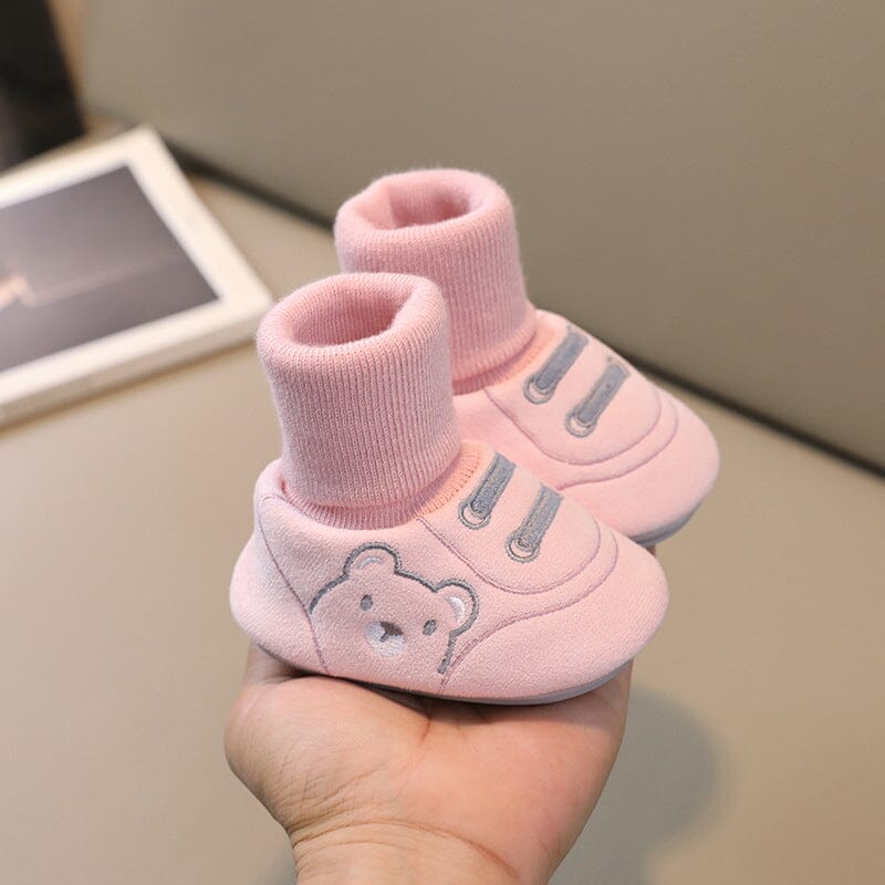 Collection of various colored plush baby booties, essential warm infant footwear