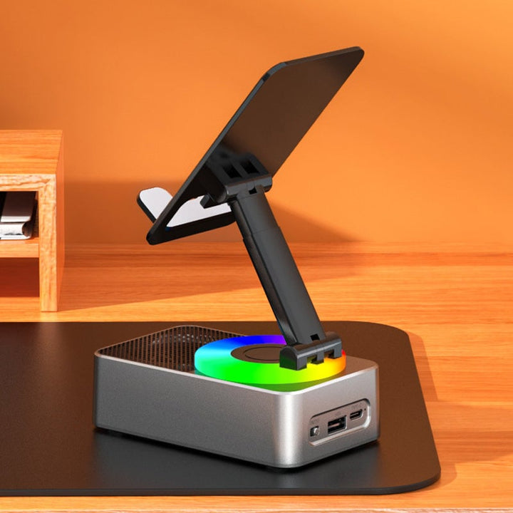Universal desktop phone holder with integrated Bluetooth audio speaker and portable charger