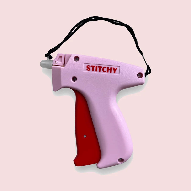 The portable clothing fixer shown with various colored fasteners, offering versatile garment repair